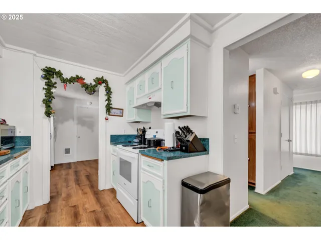 a kitchen with cabinets appliances and a window