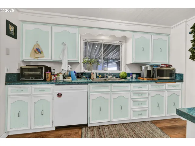 a kitchen with kitchen island granite countertop lots of counter top space and stainless steel appliances