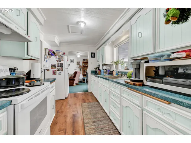a view of kitchen with fridge and rack