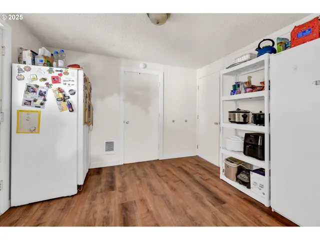 a view of a room with toys and wooden floor