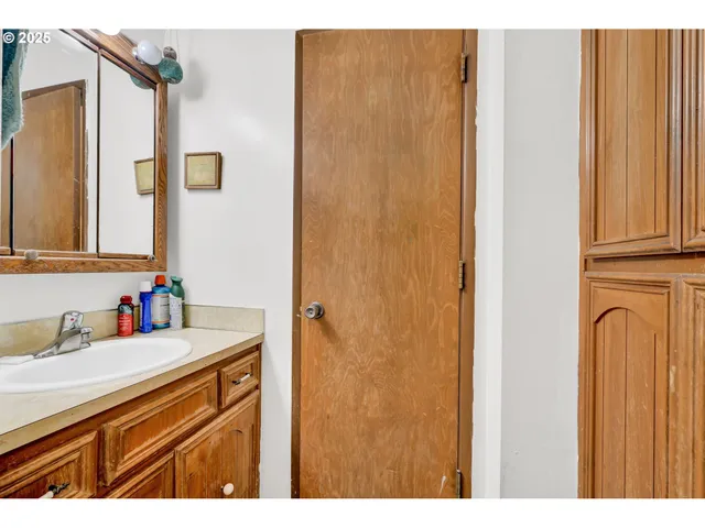 a bedroom with bed and a book shelf
