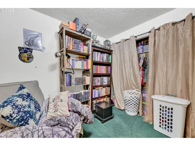 a bed room with a bed mirror and a flat tv screen
