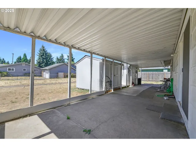 a view of a dry yard with trees