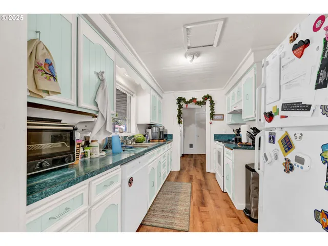 a kitchen with a refrigerator and a stove