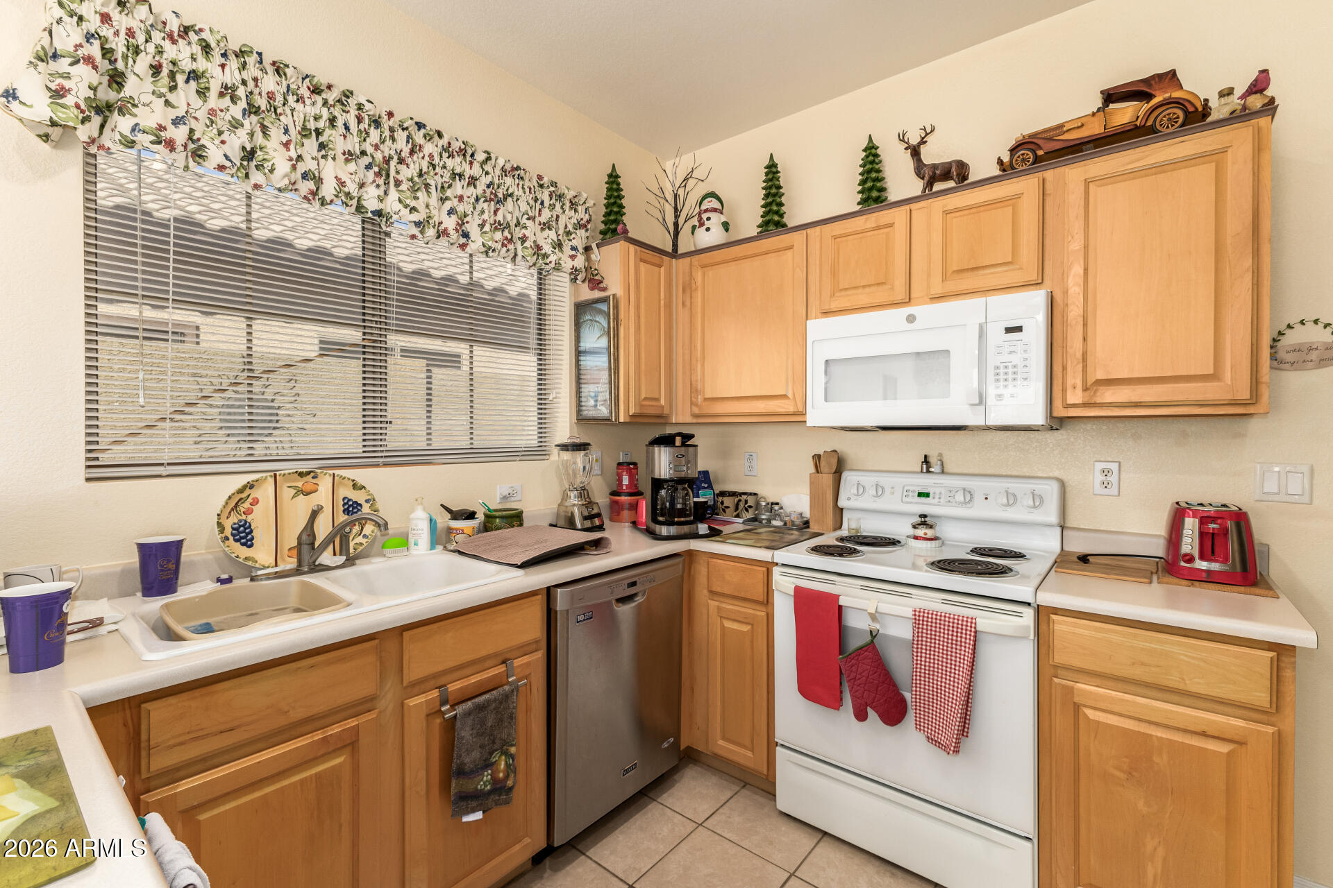 3448 West Webster Court Anthem, AZ 85086 - Photo 12 of 40 a kitchen with a sink stove top oven and cabinets