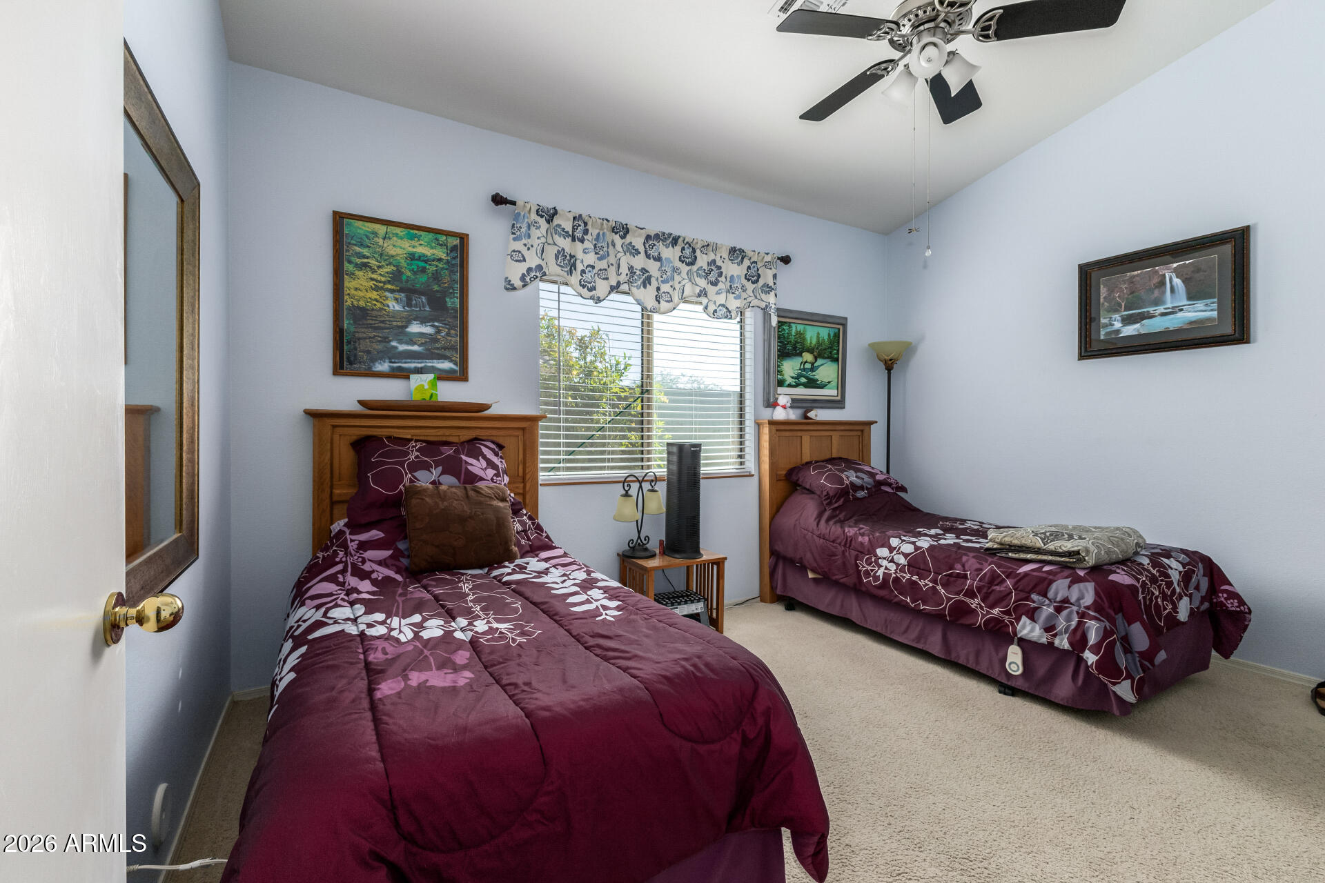3448 West Webster Court Anthem, AZ 85086 - Photo 17 of 40 a bed sitting in a bedroom next to a window