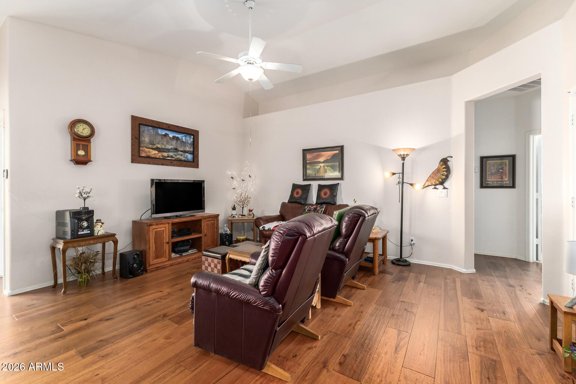 3448 West Webster Court Anthem, AZ 85086 - Photo 2 of 40 a living room with furniture and a flat screen tv
