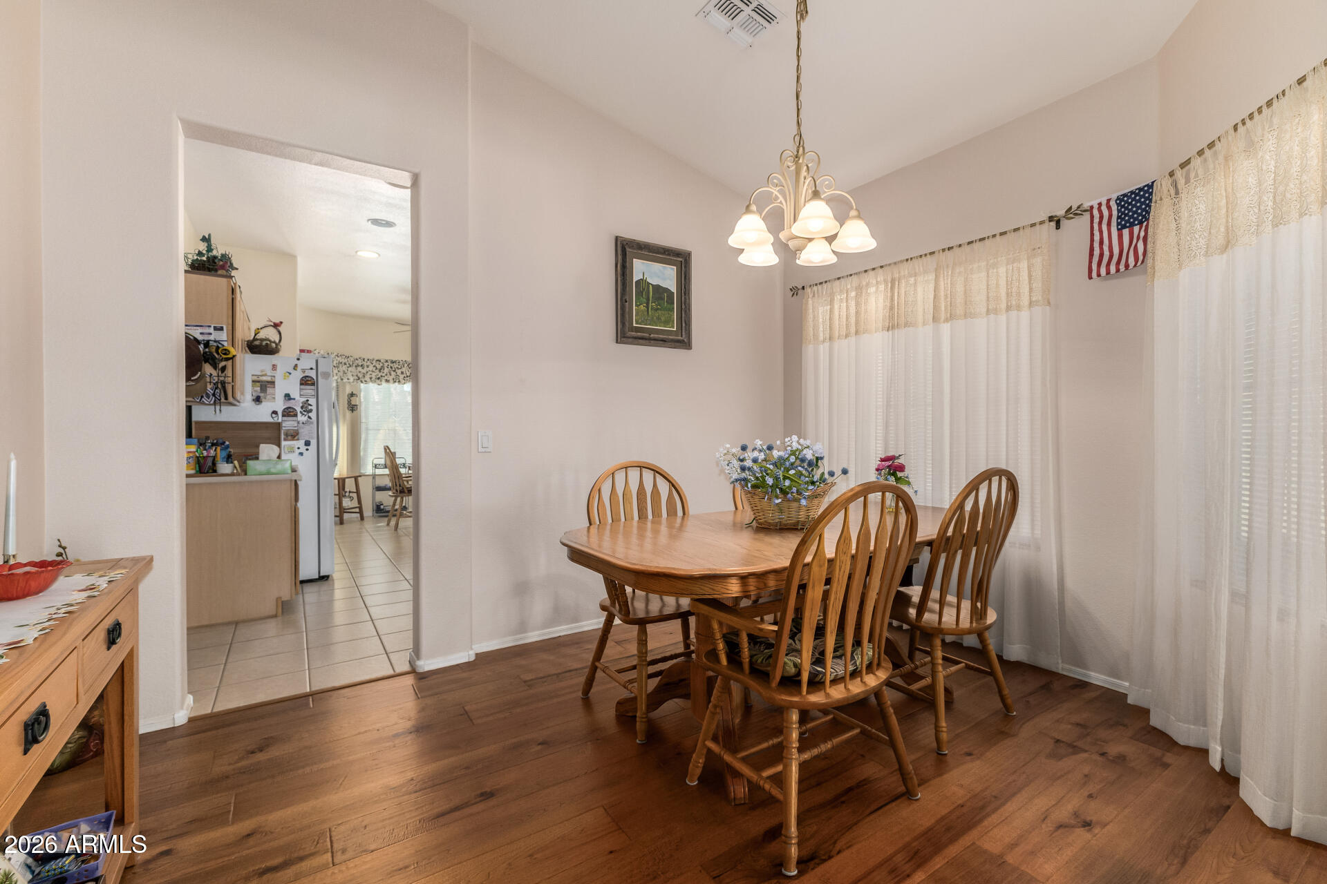 3448 West Webster Court Anthem, AZ 85086 - Photo 3 of 40 a view of a dining room with furniture window and wooden floor