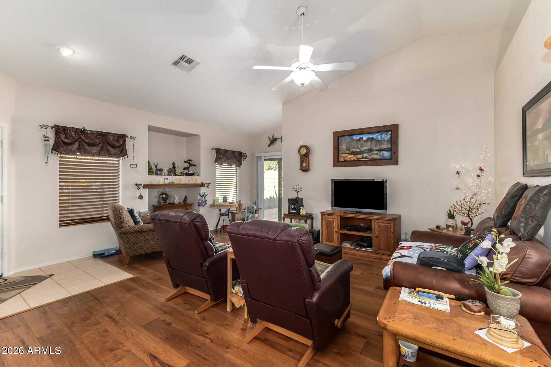 3448 West Webster Court Anthem, AZ 85086 - Photo 8 of 40 a living room with furniture a fireplace and a flat screen tv