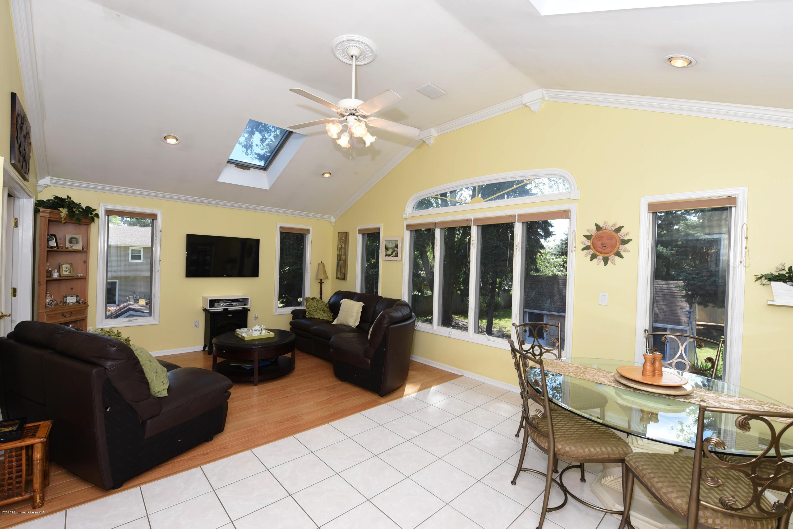 22 Walling Road Freehold, NJ 07728 - Photo 18 of 36 a living room with furniture a flat screen tv and large window