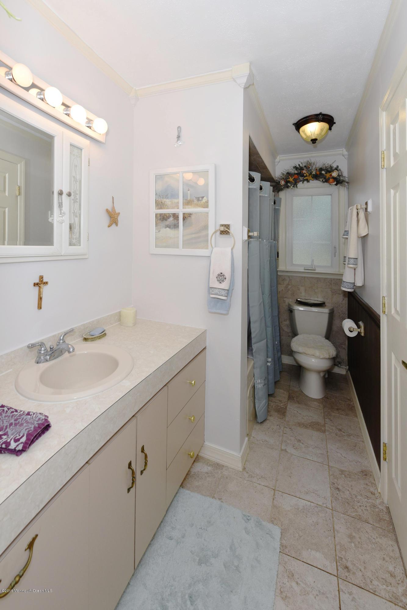 22 Walling Road Freehold, NJ 07728 - Photo 27 of 36 a bathroom with a sink a toilet and shower