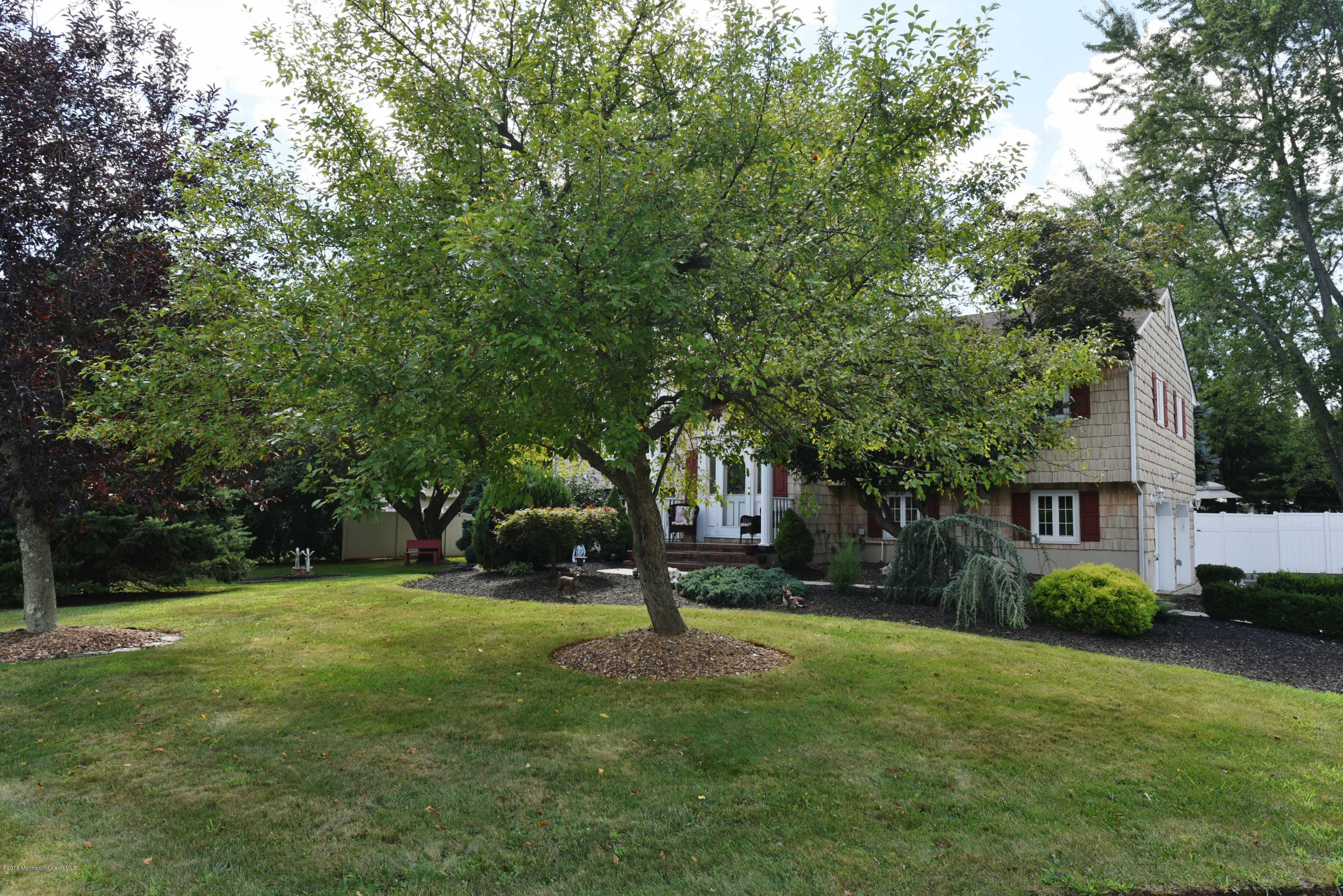 22 Walling Road Freehold, NJ 07728 - Photo 3 of 36 a view of a house with a tree in a park