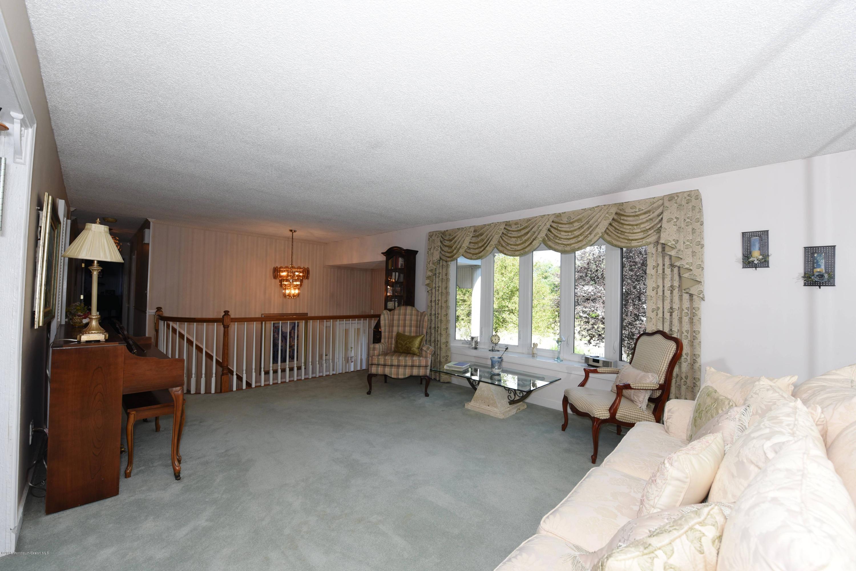 22 Walling Road Freehold, NJ 07728 - Photo 8 of 36 a living room with furniture and a large window