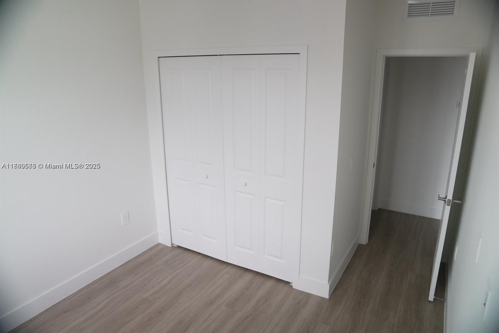 18970 Southwest 345th Terrace Homestead, FL 33034 - Photo 15 of 19 a view of an empty room with wooden floor