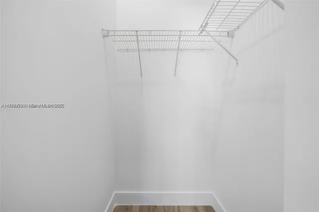 a view of walk in closet with empty racks