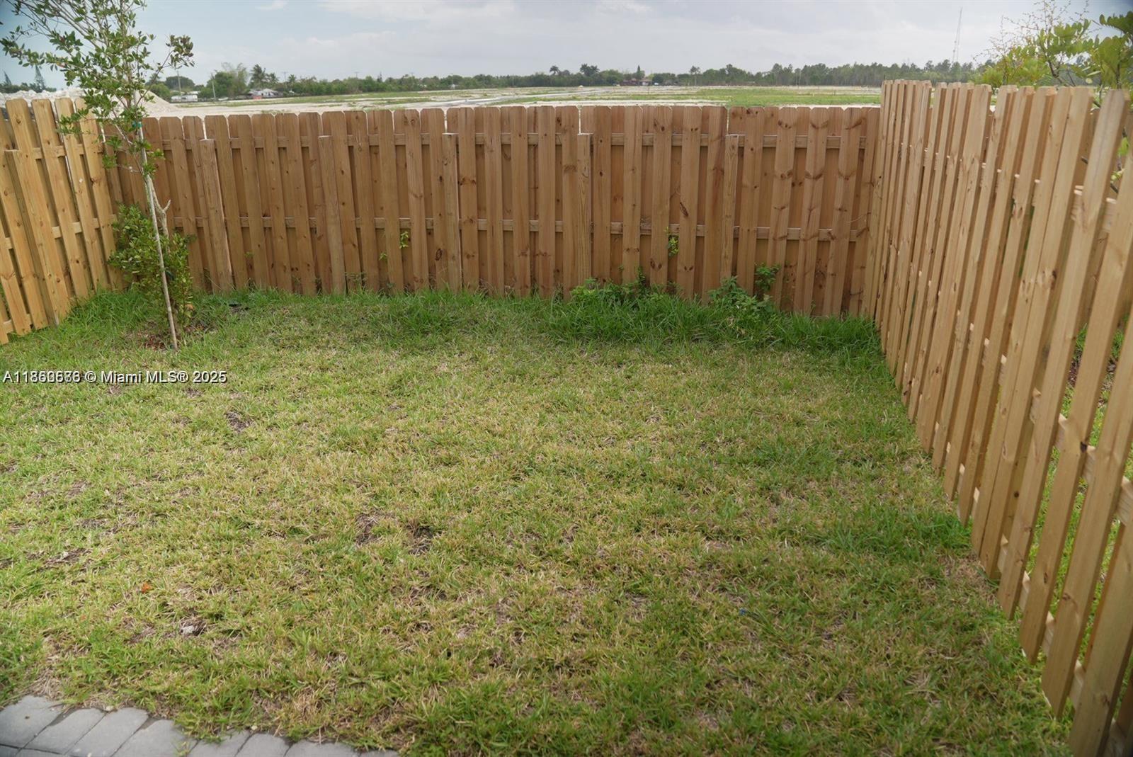 18970 Southwest 345th Terrace Homestead, FL 33034 - Photo 19 of 19 a view of a backyard with wooden fence