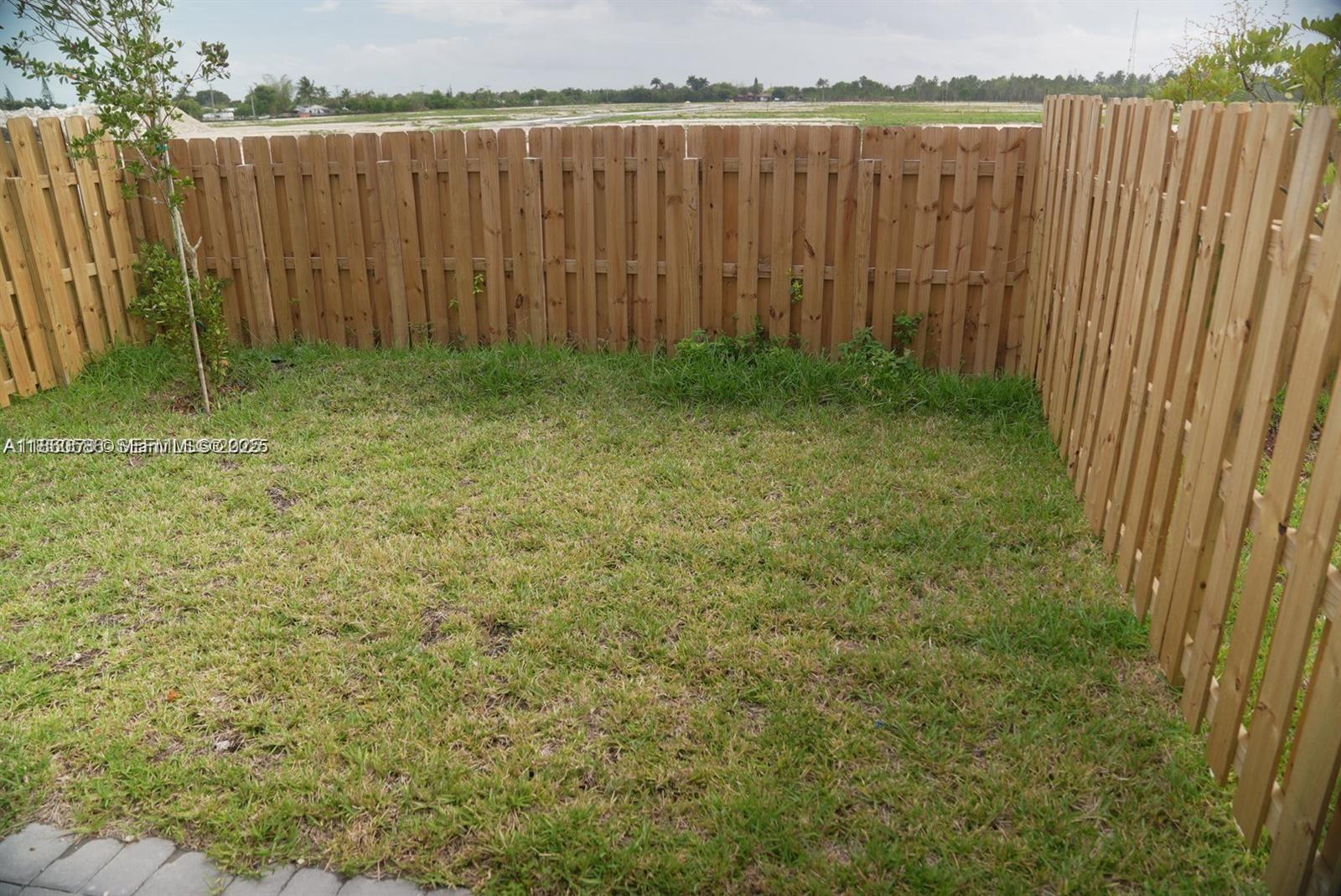 18970 Southwest 345th Terrace Homestead, FL 33034 - Photo 20 of 20 a view of a backyard with wooden fence