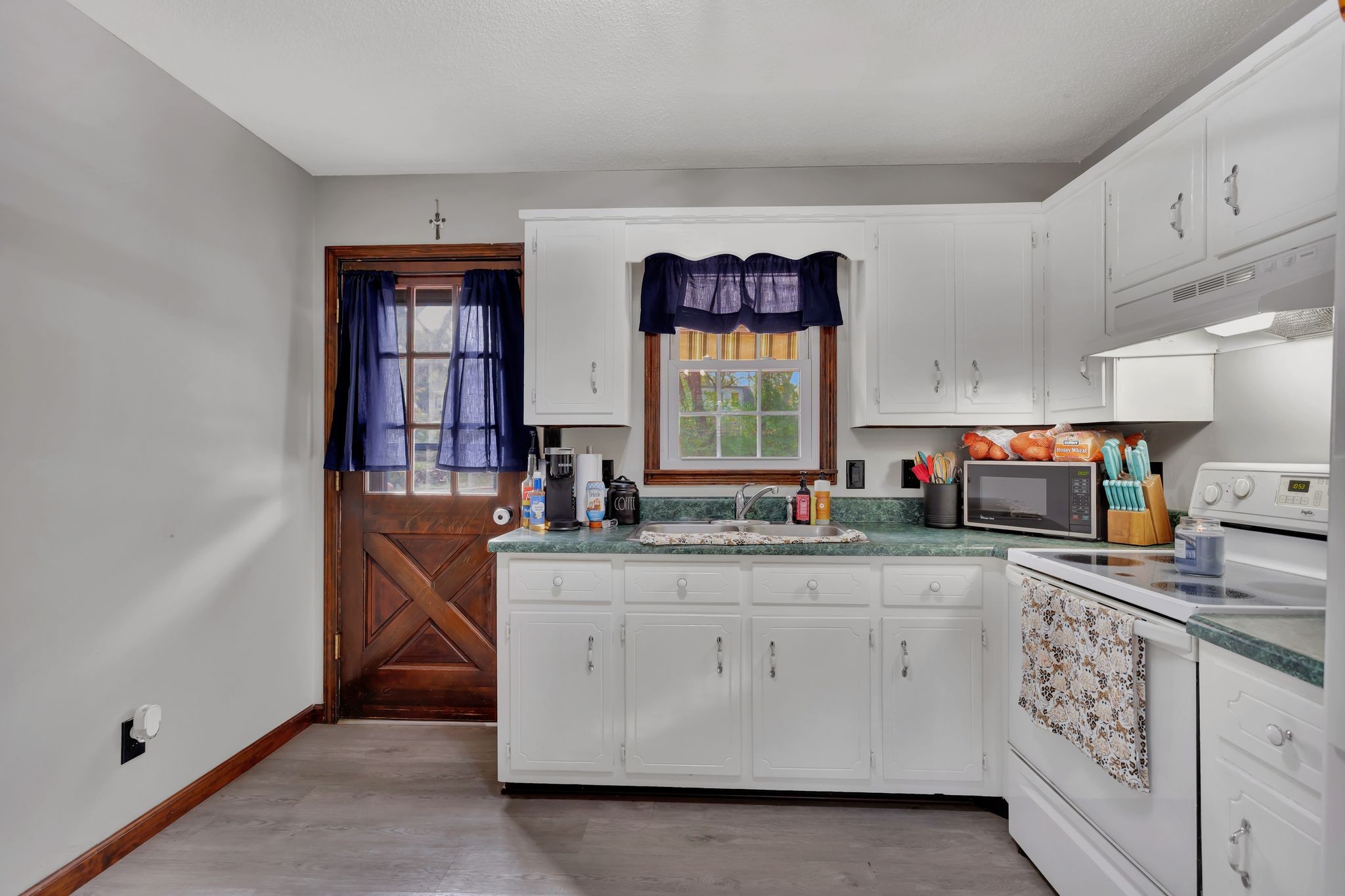 108 8th Avenue Columbia, TN 38401 - Photo 23 of 30 a kitchen with granite countertop a sink and cabinets