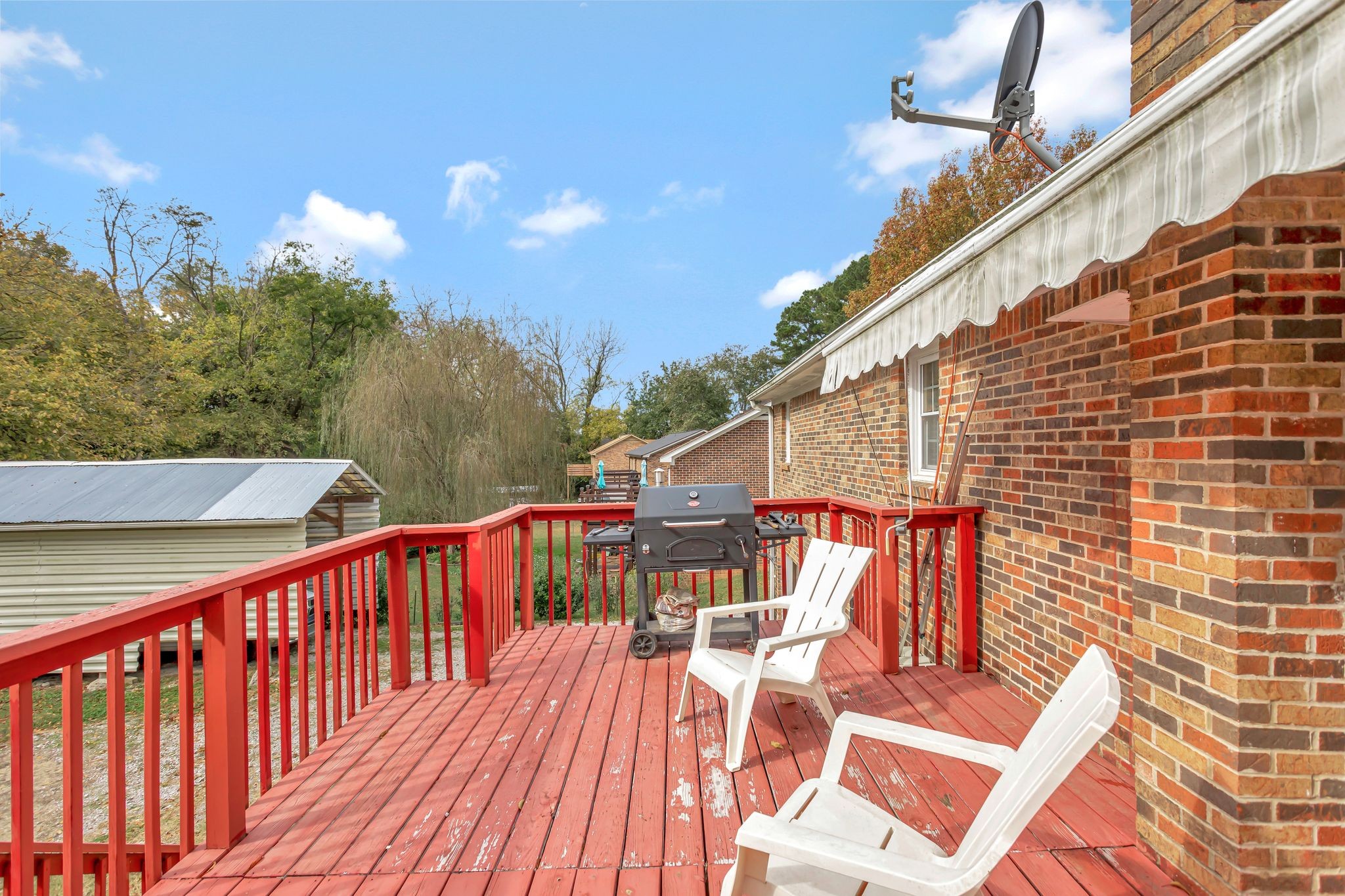 108 8th Avenue Columbia, TN 38401 - Photo 5 of 30 a balcony of a house with wooden floor and outdoor seating