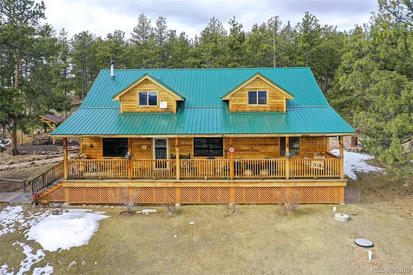 a view of front house with wooden fence