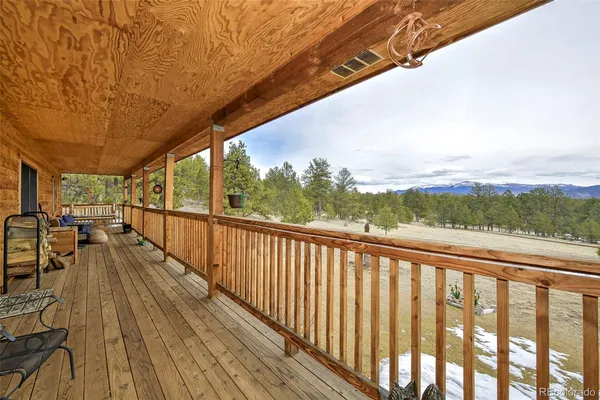a view of balcony with wooden floor and city view