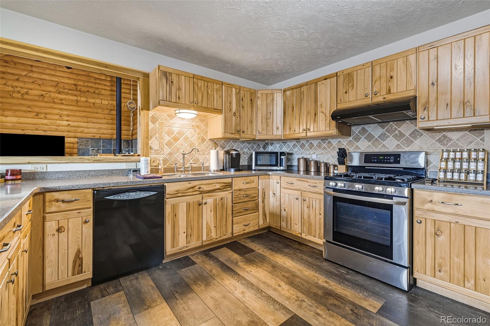 111 Twinkle Road Guffey, CO 80820 - Photo 17 of 39 a kitchen with stainless steel appliances granite countertop a stove sink and cabinets