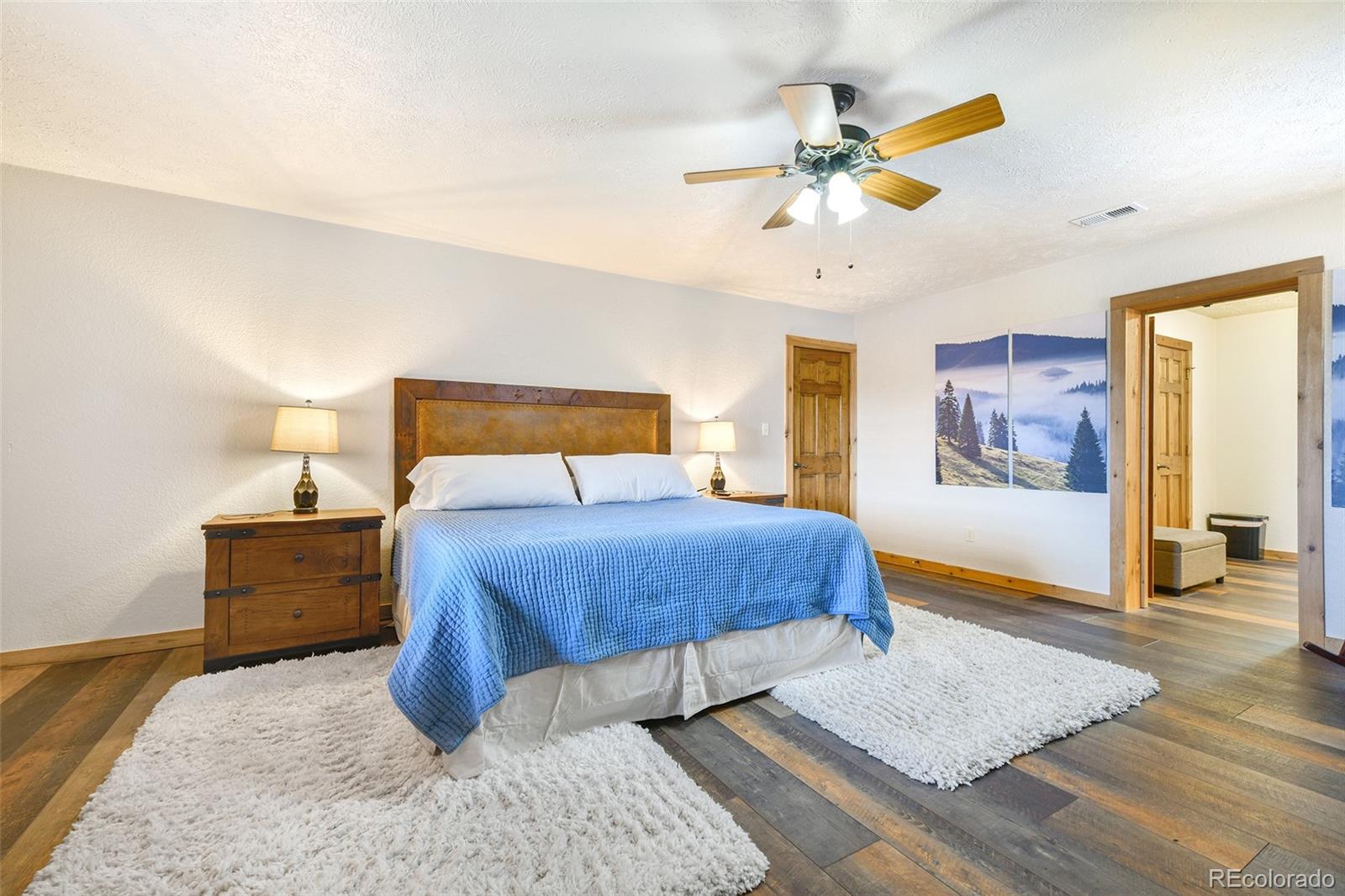 111 Twinkle Road Guffey, CO 80820 - Photo 22 of 39 a bedroom with a bed rug and wooden floor