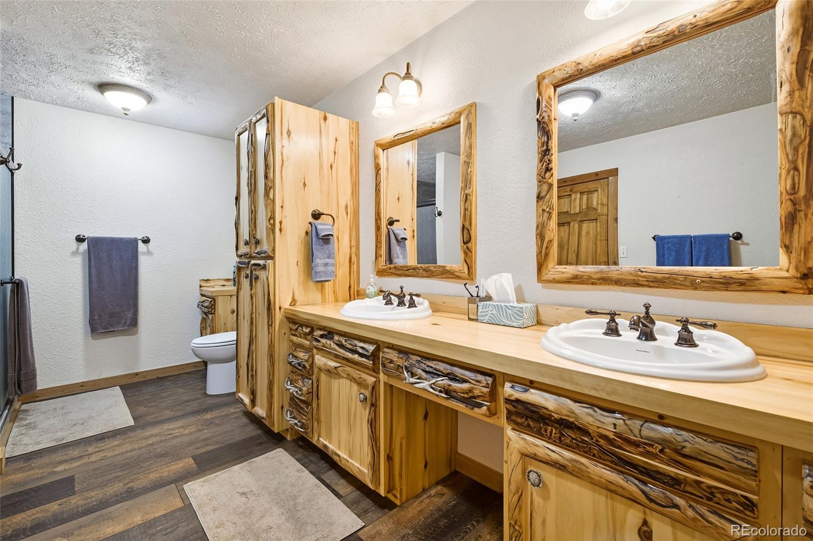 111 Twinkle Road Guffey, CO 80820 - Photo 23 of 39 a spacious bathroom with double vanity and a mirror