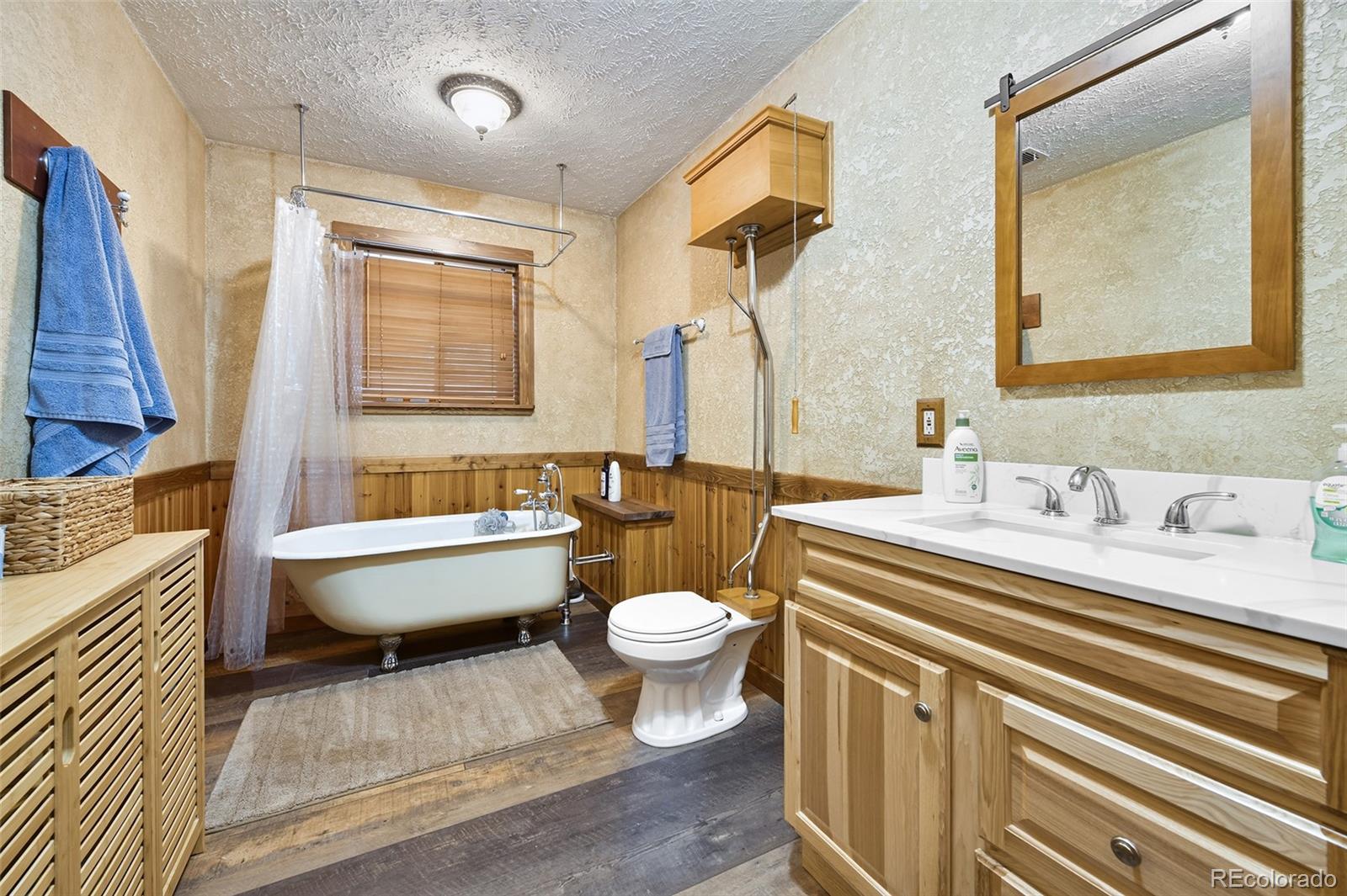 111 Twinkle Road Guffey, CO 80820 - Photo 25 of 39 a bathroom with a granite countertop toilet a sink and a mirror