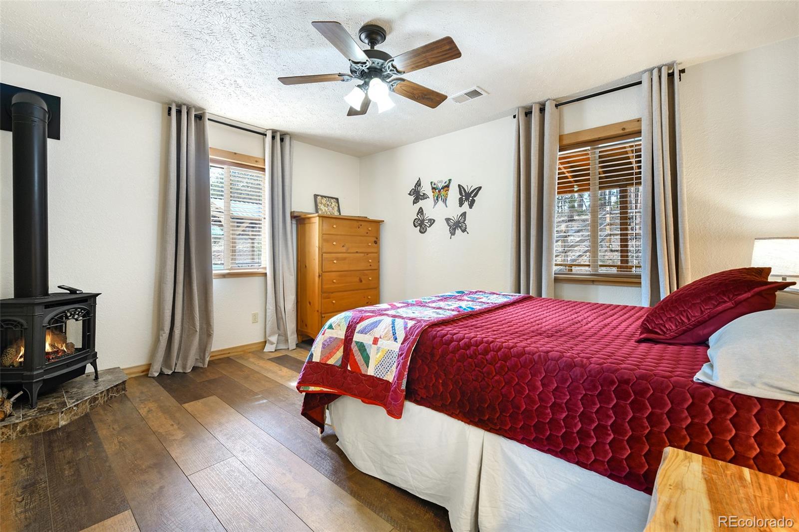 111 Twinkle Road Guffey, CO 80820 - Photo 26 of 39 a bedroom with a bed dresser and a flat tv screen