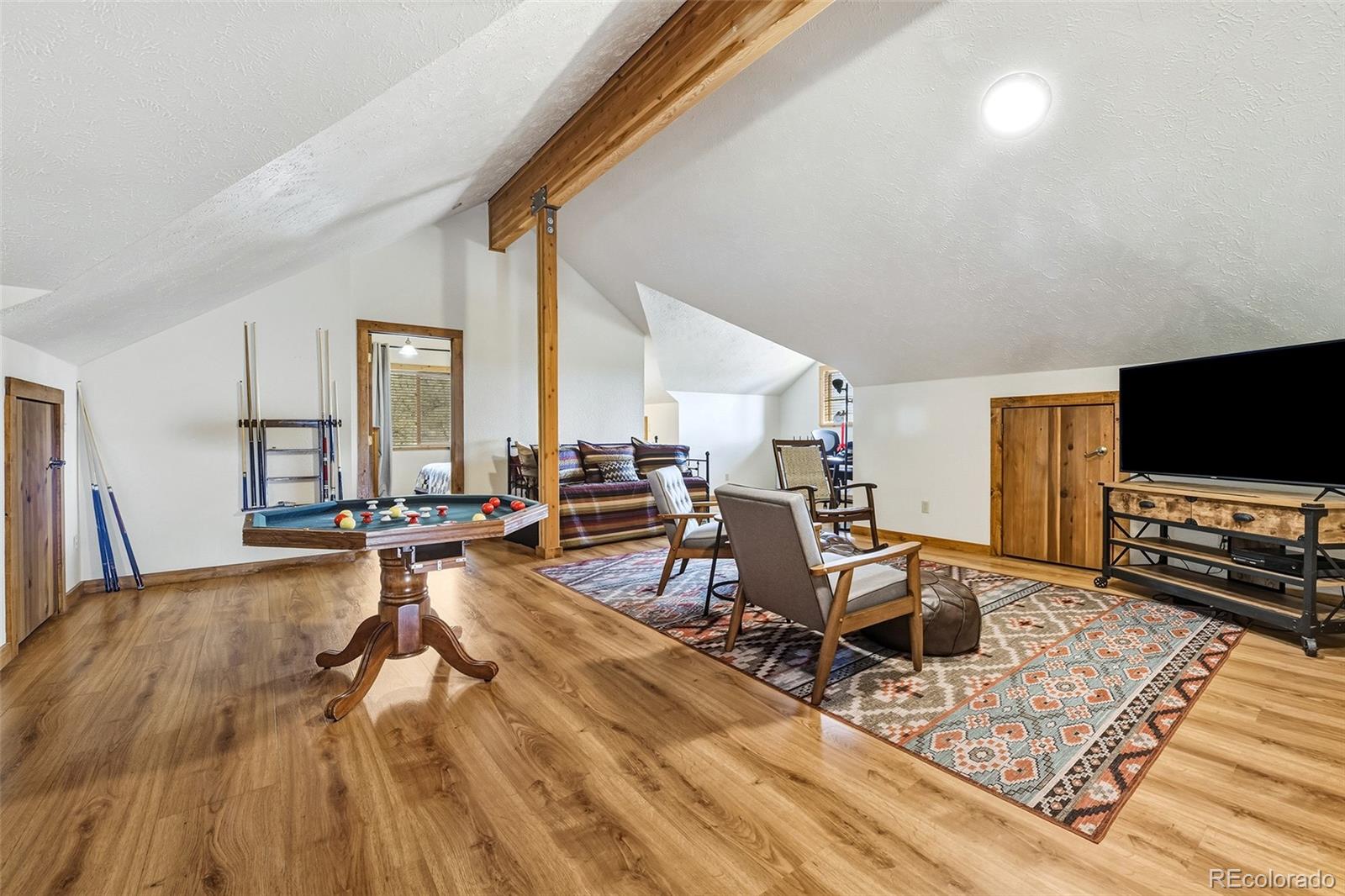 111 Twinkle Road Guffey, CO 80820 - Photo 27 of 39 a living room with furniture and a flat screen tv