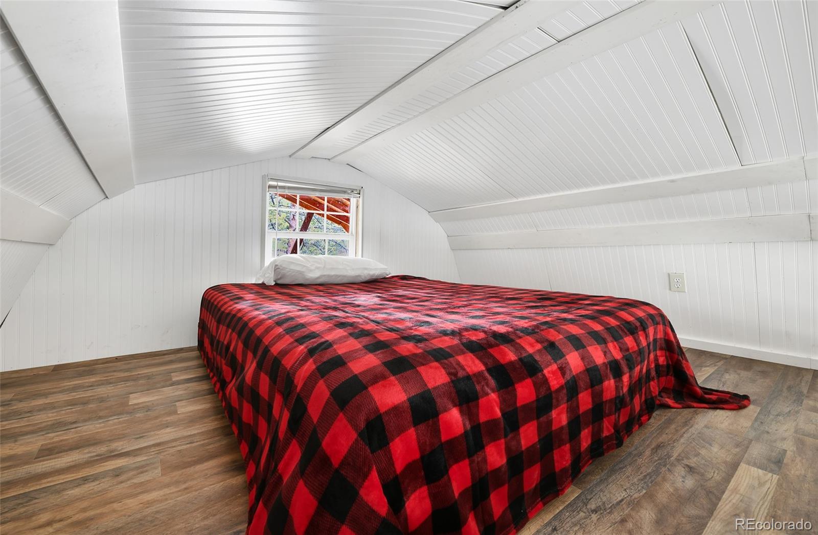 111 Twinkle Road Guffey, CO 80820 - Photo 35 of 39 a bedroom with a bed and a painting on the wall