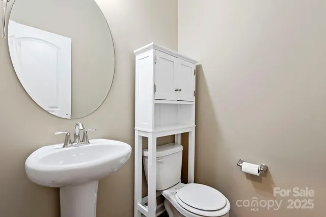 a bathroom with a sink toilet and mirror