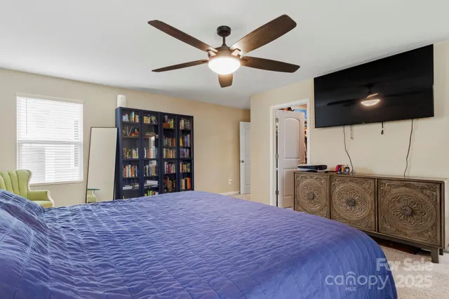 a bedroom with a large bed and a flat screen tv