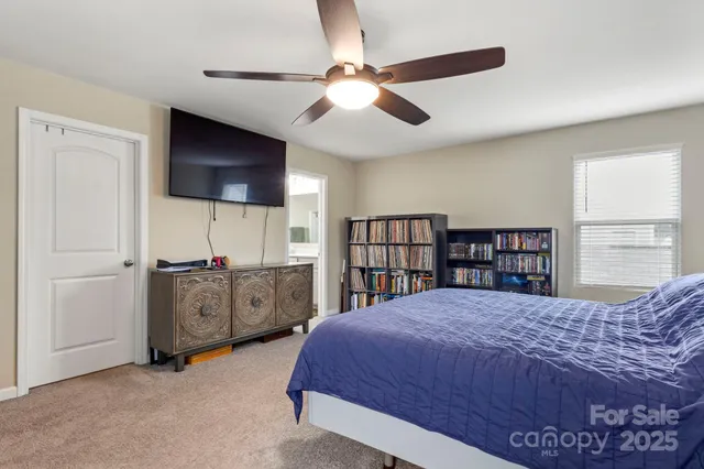 a bedroom with a large bed and a flat screen tv