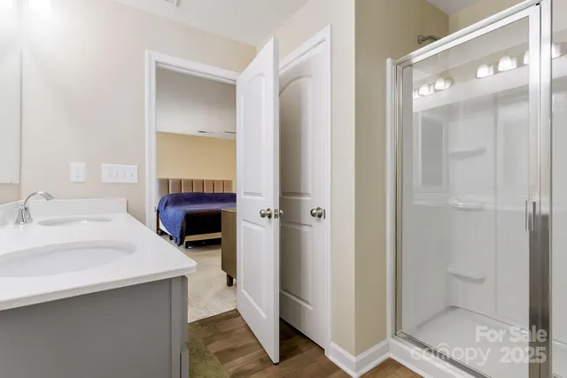 a en suite bathroom with a sink a mirror and a shower