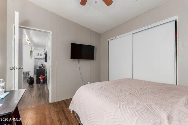 a bedroom with a bed and a flat screen tv