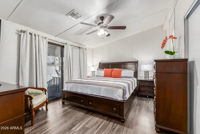 a bedroom with a bed and wooden floor