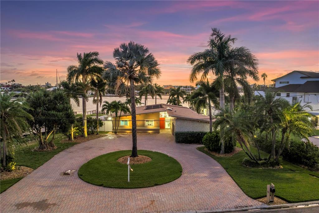 16 Treasure Lane Treasure Island, FL 33706 - Photo 1 of 1 a swimming pool with an outdoor space and seating area
