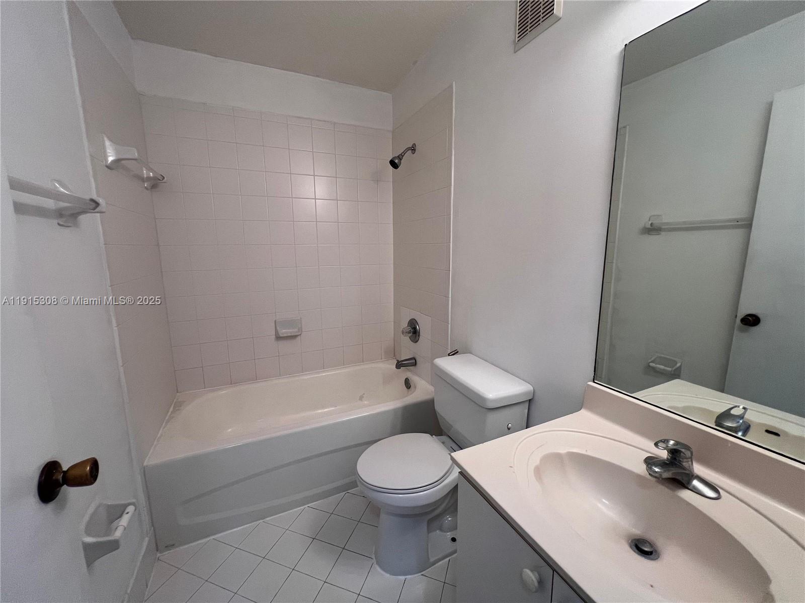 1261 Southeast 31st Court, Unit 20453 Homestead, FL 33035 - Photo 14 of 15 a bathroom with a sink a toilet and shower