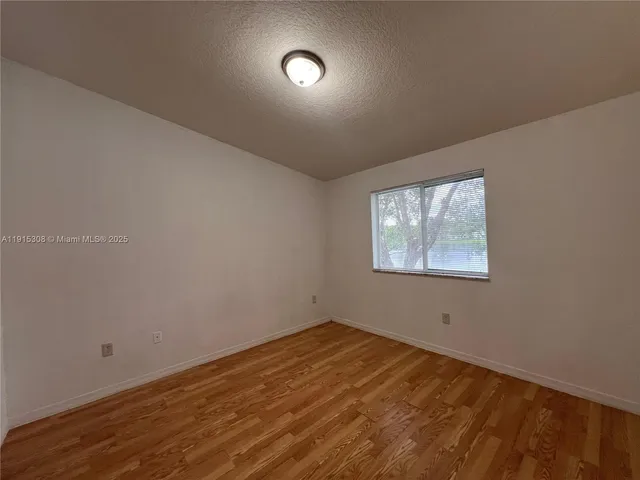 an empty room with a empty space and windows