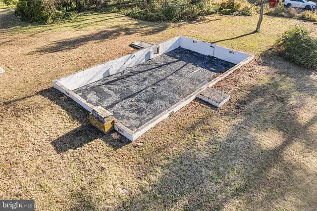 a wooden bench sitting in the middle of a yard
