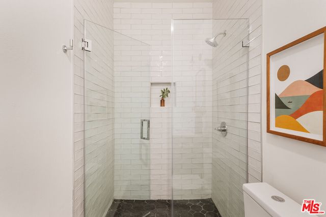 a bedroom with bed and a potted plant