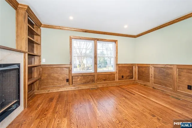 a large kitchen with stainless steel appliances a lot of counter space and a wooden floor