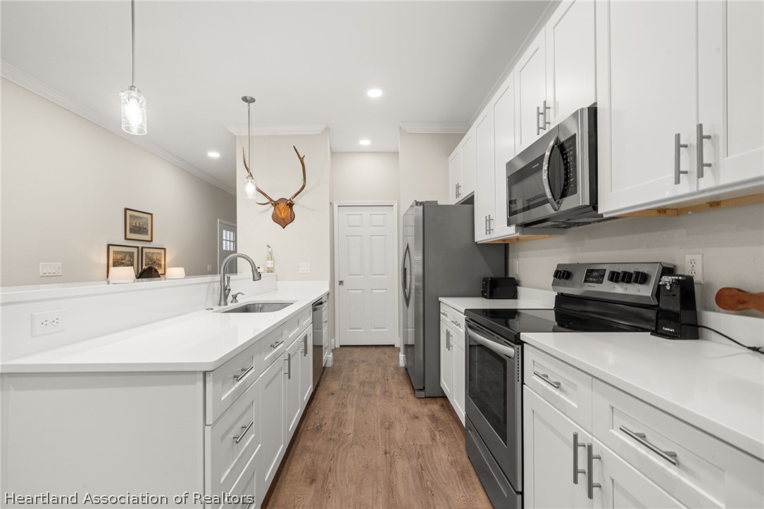 4734 Haw Branch Road, Unit 110 Sebring, FL 33875 - Photo 9 of 50 a kitchen with cabinets and steel stainless steel appliances