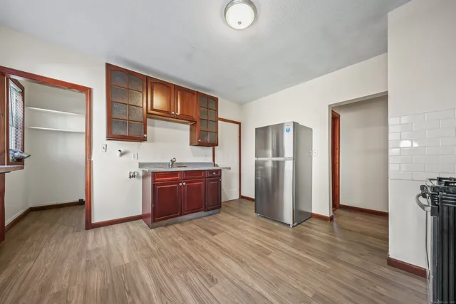 a kitchen with stainless steel appliances granite countertop a refrigerator and a stove top oven