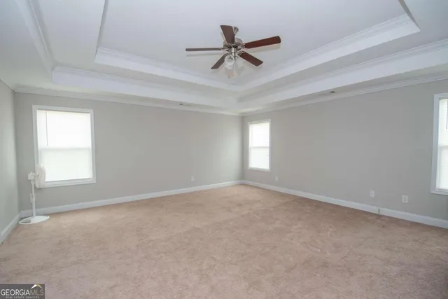 a view of a livingroom with a ceiling fan and window