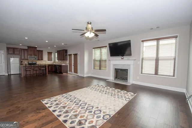 an open kitchen with a flat screen tv and a fireplace