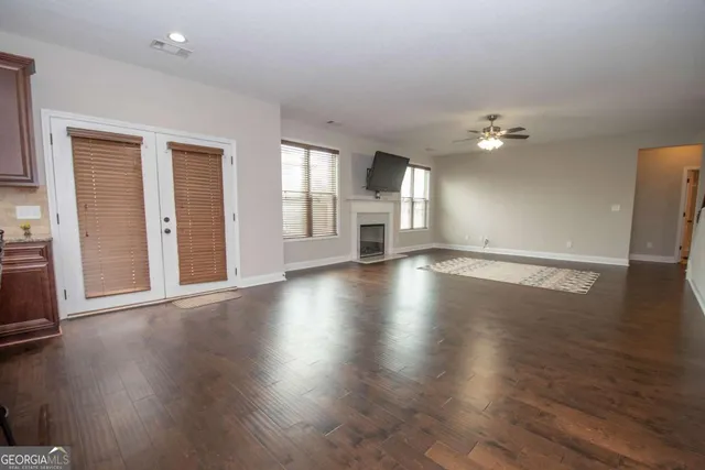 an empty room with wooden floor and window