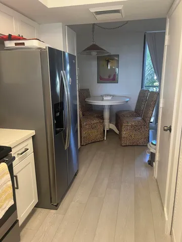 a kitchen with refrigerator and window